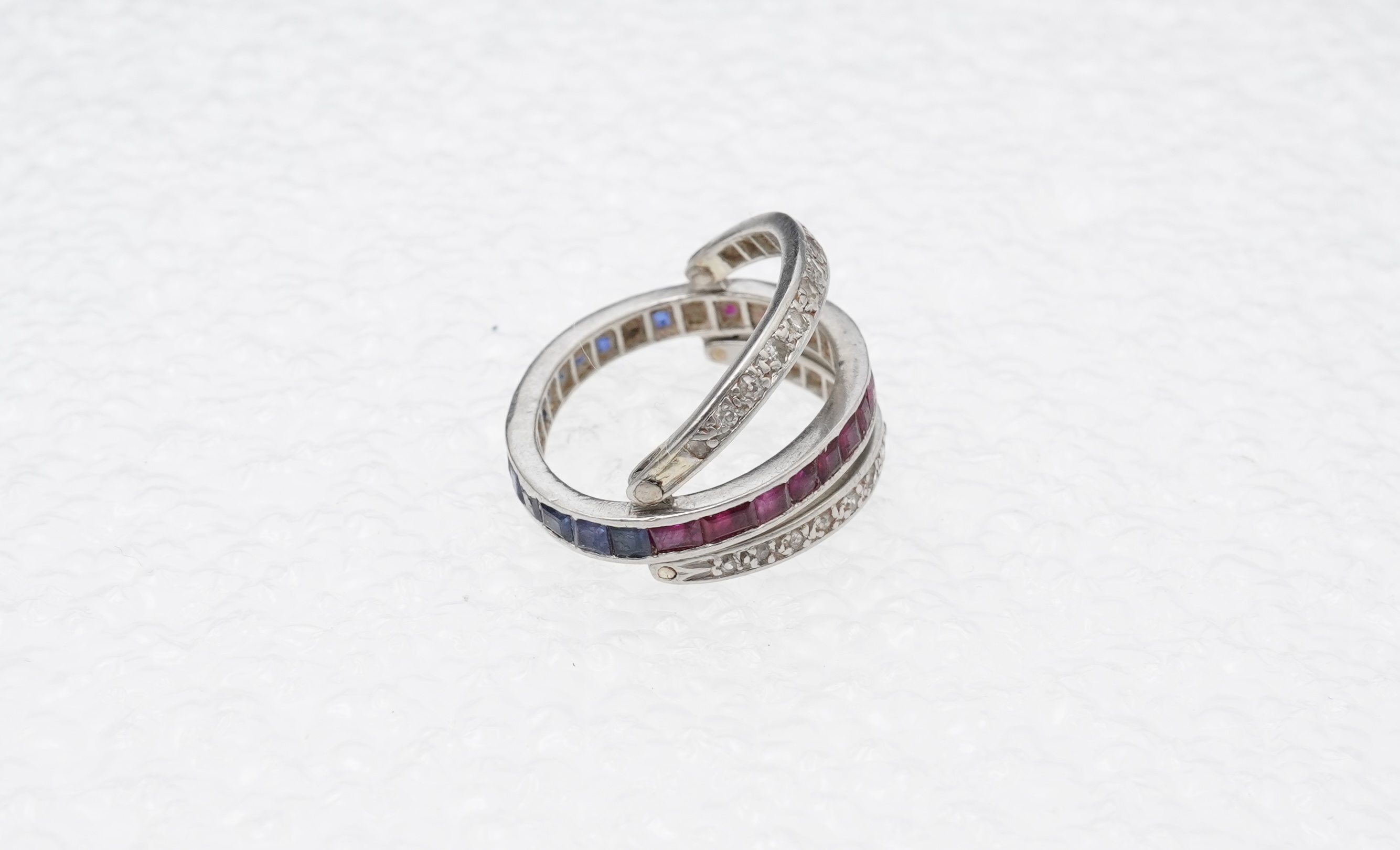 A ruby, sapphire and diamond 'Day and Night' ring, mid 20th century